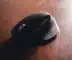black cordless computer mouse on brown wooden table
